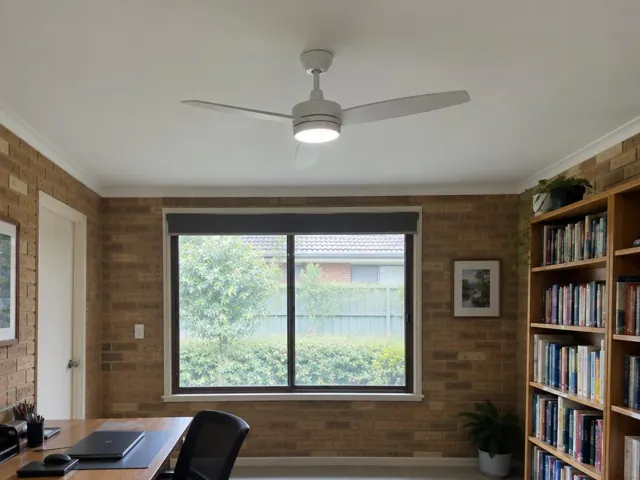 Brick home study with a ceiling fan and light on a white ceiling in Springfield